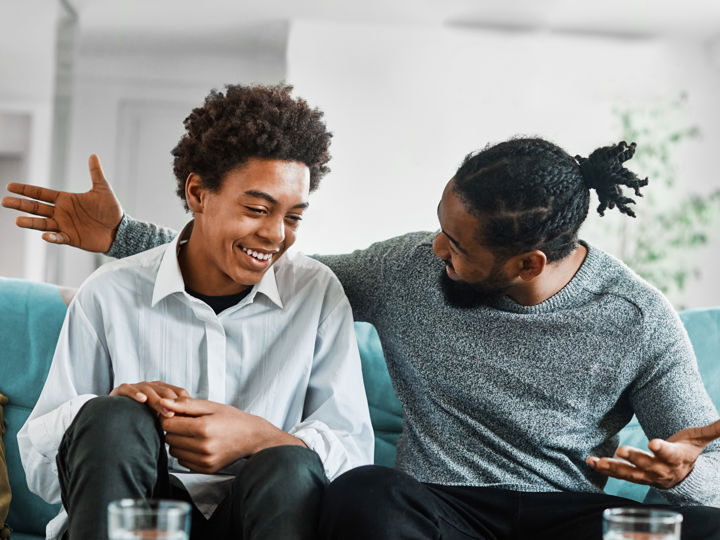 Man and teenager sitting on sofa.jpg