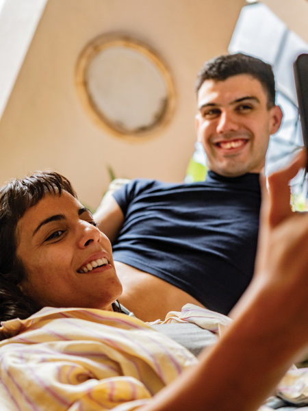 Two people relaxed while looking at a phone.jpg