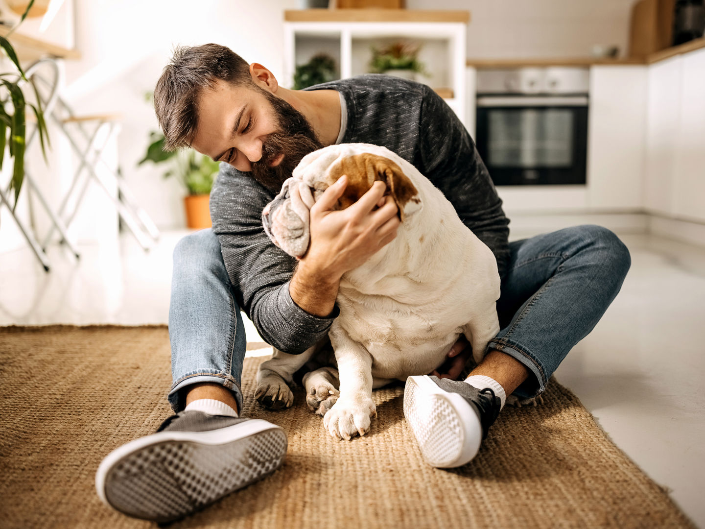 Man sitting on the floor with a dog